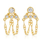 A pair of fine 14k yellow gold post drop earrings featuring four round bezel-set white diamonds on each earring arranged in a tiered, triangular cluster. Three delicate loops of mariner link chain suspend gracefully beneath the stones, creating a fluid dangle fringe against a clean white background.
