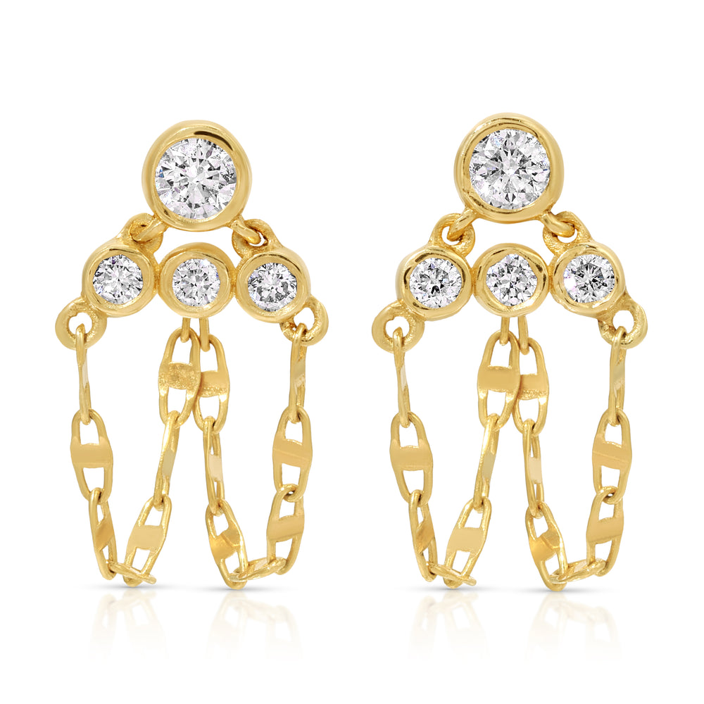 A pair of fine 14k yellow gold post drop earrings featuring four round bezel-set white diamonds on each earring arranged in a tiered, triangular cluster. Three delicate loops of mariner link chain suspend gracefully beneath the stones, creating a fluid dangle fringe against a clean white background.