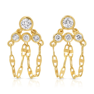 A pair of fine 14k yellow gold post drop earrings featuring four round bezel-set white diamonds on each earring arranged in a tiered, triangular cluster. Three delicate loops of mariner link chain suspend gracefully beneath the stones, creating a fluid dangle fringe against a clean white background.